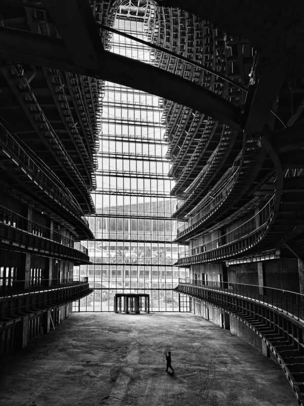 Black and white photo of a towering interior courtyrd of a modrn building