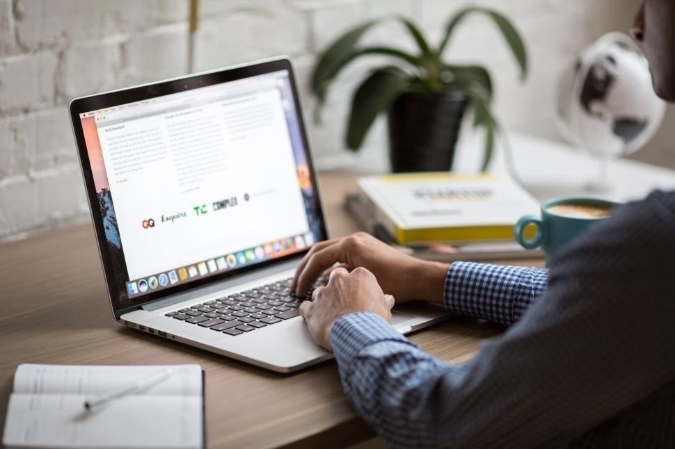 Man using a MacBook Air to write