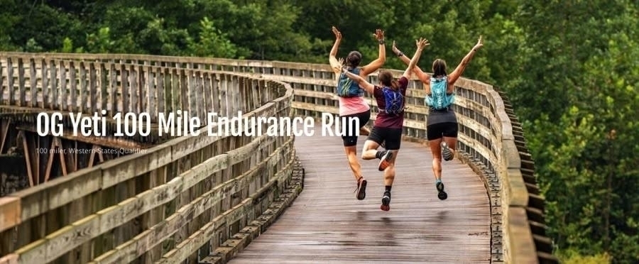 Three ultra runners leaping for joy on a wooden trestle