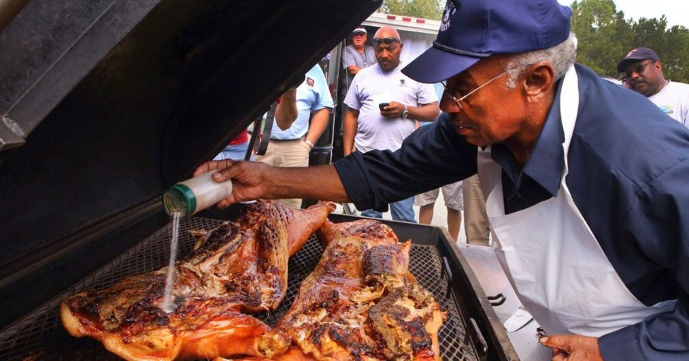 Man cooking whole hog barbecue