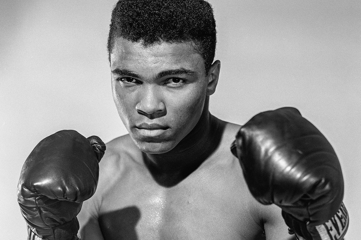 Muhammed Ali at age 24 shown with boxing gloves in a fighting stance