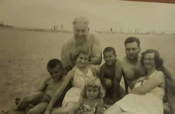 Vintage photo from the 40s of a family at the beach