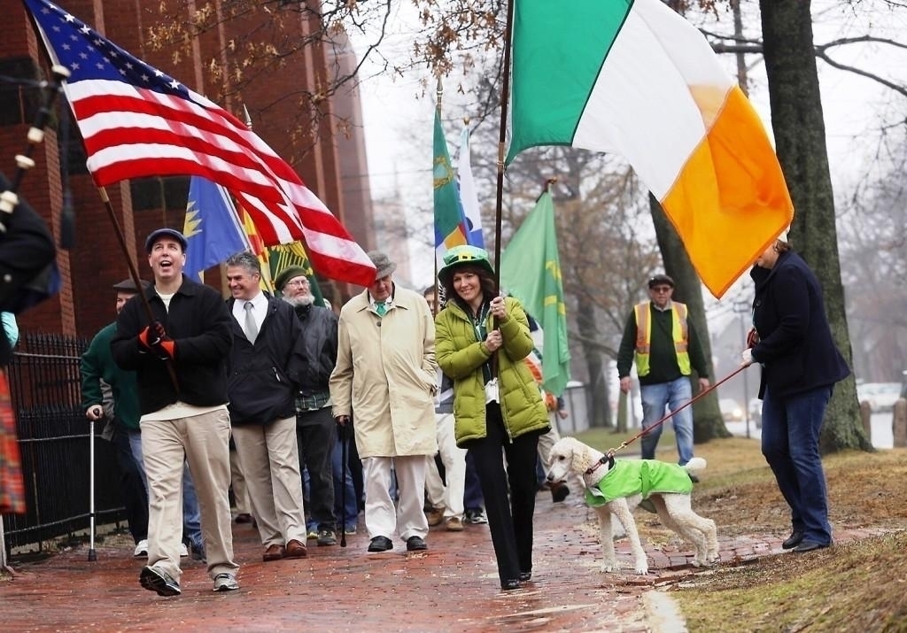 People marching with the Irish and American flags,