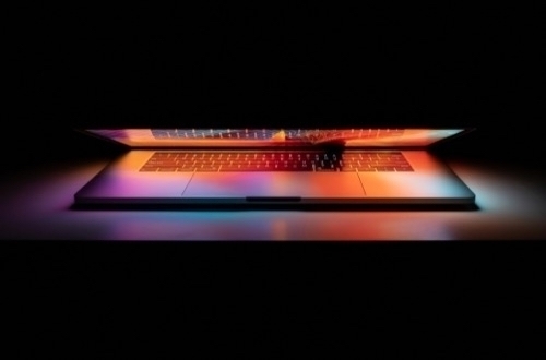 A laptop illuminated only by what’s on the screen
