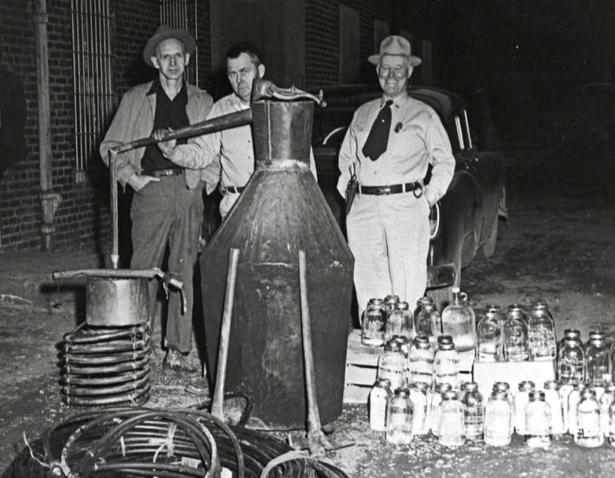 Law enforcement men standing around a captured still