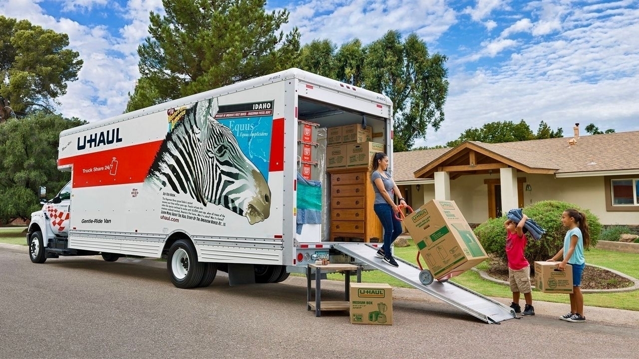 Uhaul truck being unloaded in front of a house