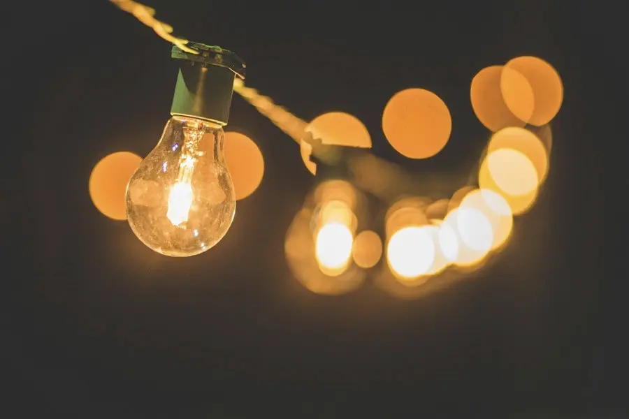 A string of old fashioned light bulbs against a dark background