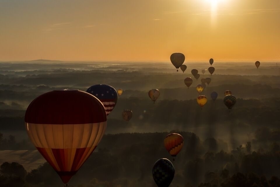 Hot air balloons in flight at dawn