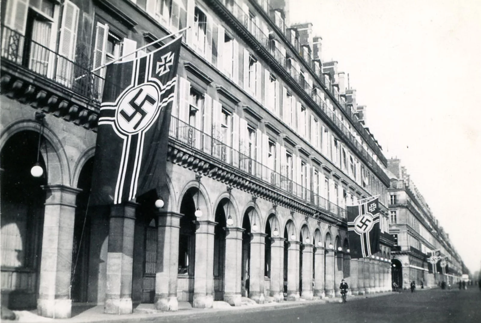 A photograph of Paris' Le Meurice hotel in Rue de Rivoli flanked by the flags of Nazi Germany.