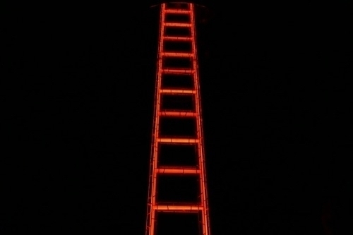 a red ladder against a black background