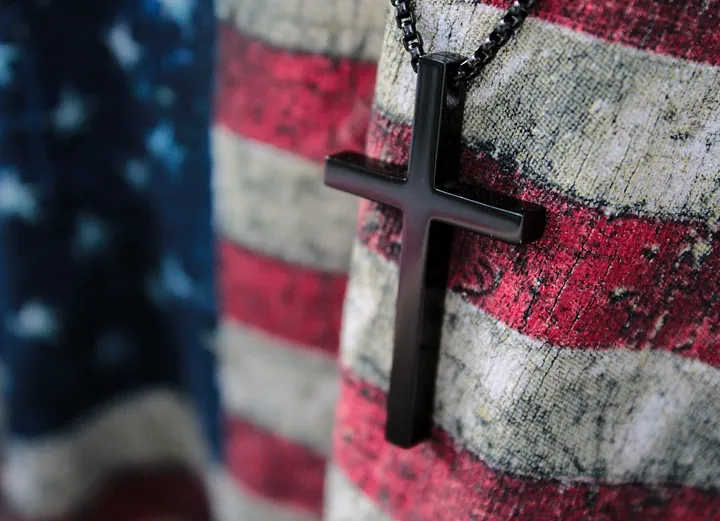 A cross against a flag