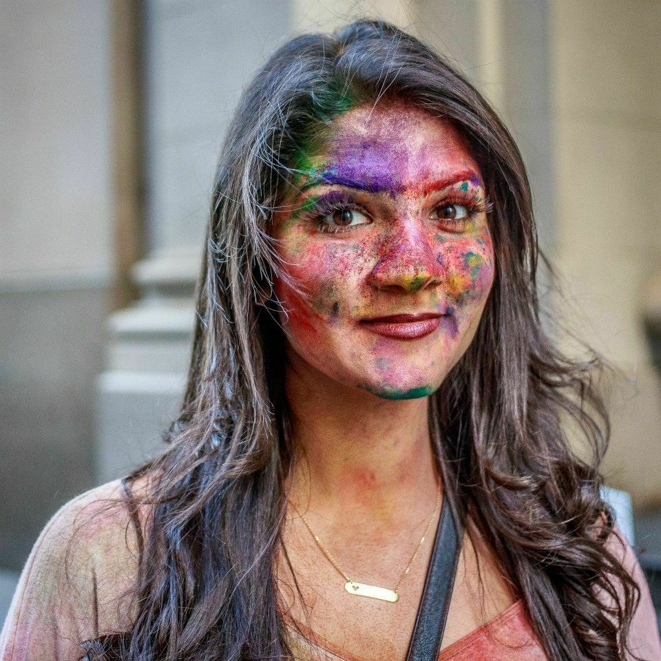 A woman with her face streaked in multi-colored chalk