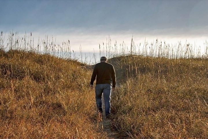 Man walking in sand dunes