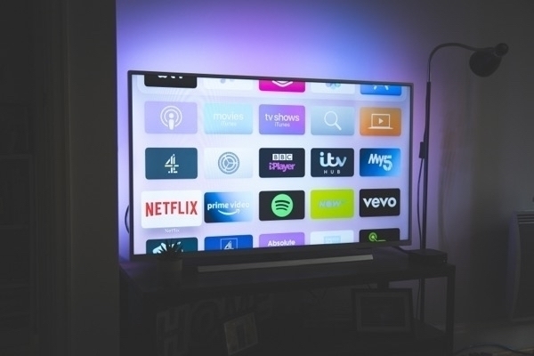 A tv with various apps showing on the screen